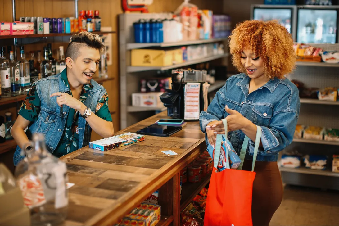 A shopkeeper helping a customer at a local store counter